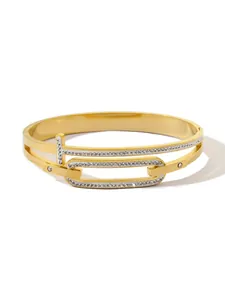 Close-up of gold-plated titanium steel bangle with T-bar link and rhinestones