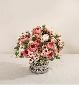 Elegant artificial peony flower bouquet in a decorative silver vase for home decor