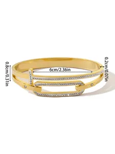 Detail view of gold titanium steel T-shaped bangle with crystal accents and measurements