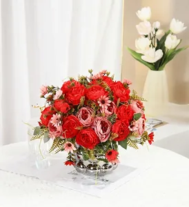 Close-up of vibrant red artificial peonies arranged in a stylish silver textured vase.
