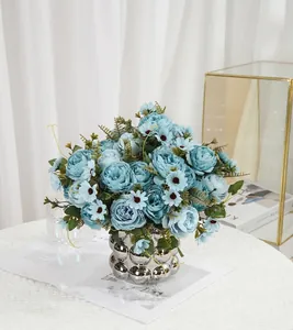 Detailed view of realistic light blue artificial peony bouquet in a silver textured vase