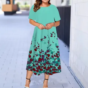 Elegant mint green summer midi dress featuring short sleeves and a floral hem print