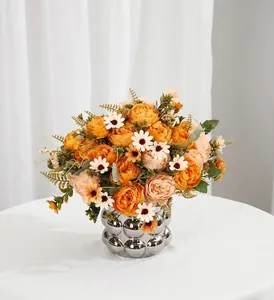 Realistic artificial orange rose bouquet in a silver bubble vase for home decor