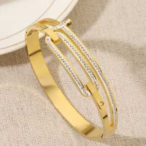 Elegant titanium steel bangle with crystal-paved T-motif and interlocking rings for women