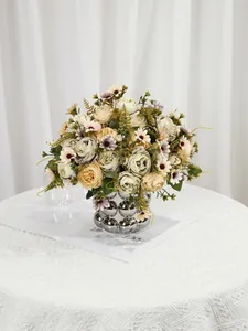 Detailed macro view of realistic artificial peony rose bouquet in silver bubble vase