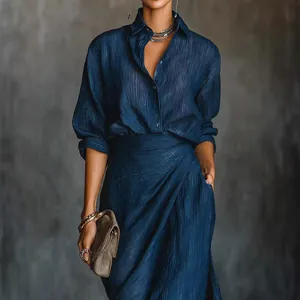 Elegant navy blue pleated long sleeve dress with irregular wrap skirt and belt.