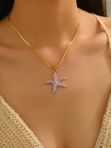 Detailed macro view of a gold-plated snake chain with a purple starfish pendant