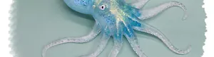 Close-up detail of a blue glitter octopus squishy toy with translucent TPR texture.