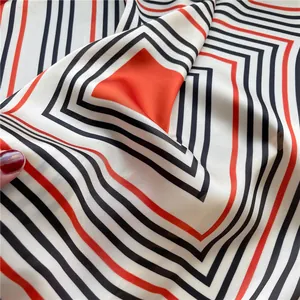 Close-up of geometric striped imitation silk scarf showing smooth texture and drape