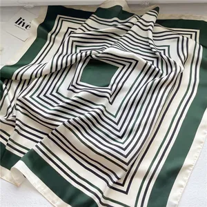 Close-up of green and cream striped geometric silk-like square scarf