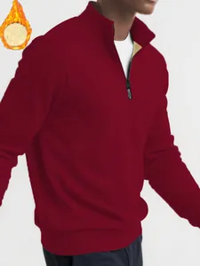 Close-up detail of men's burgundy quarter-zip sweatshirt featuring warm fleece lining