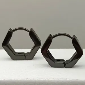 Macro detail view of minimalist black hexagonal titanium steel hoop earrings for unisex