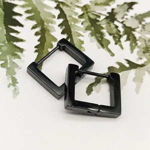 Detailed macro shot of black square titanium steel hoop earrings with a sleek finish.
