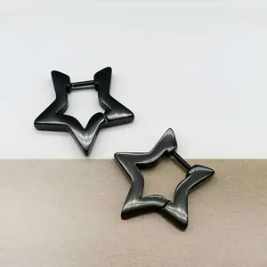 Close-up of black titanium steel star-shaped hoop earrings on split background