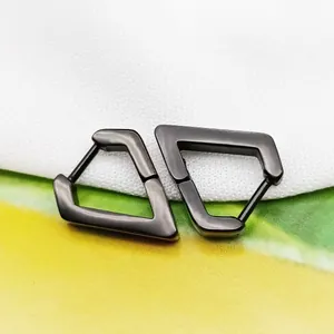 Macro detail view of gunmetal black geometric trapezoid earrings crafted from titanium steel.