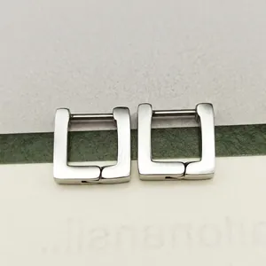 Close-up of polished silver square hoop earrings with secure hinge closure