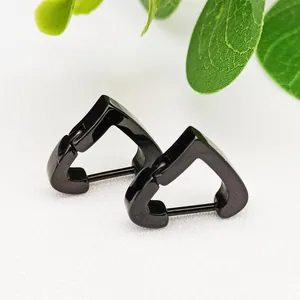 Detail view of black heart-shaped titanium steel hoop earrings on white background