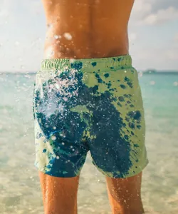 Detailed view of men's color-changing swim trunks reactive to water turning blue.