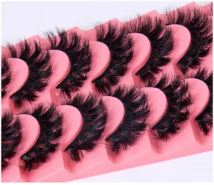 Detailed close-up showing 7 pairs of thick D-curl wispy false eyelashes on a pink display tray