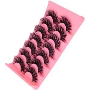 Set of 7 pairs of thick D-curl voluminous wispy false eyelashes on a pink tray.