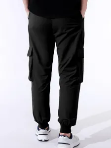 Vista posteriore pantaloni cargo neri da uomo con tasche multiple e polsini