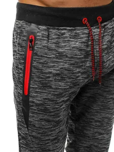 Détail d'un pantalon de sport pour hommes avec poche zippée rouge et cordon