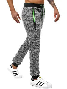 Vue latérale d'un jogging décontracté pour hommes avec motif neige et poche zippée vert fluo.