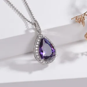 Elegant teardrop necklace featuring a faceted purple gemstone with clear zircon halo