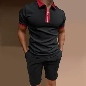 Close-up detail of men's slim-fit black polo shirt set with red contrast collar and zip