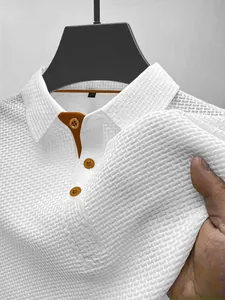 Detailed view of white ice silk mesh texture on a men's polo shirt with orange trim