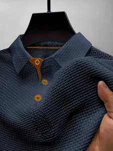 Close-up detail of navy blue men's ice silk mesh polo shirt showing fabric texture.