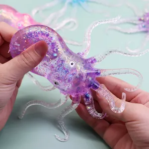 Translucent glittery purple TPR octopus squishy toy being squeezed for stress relief