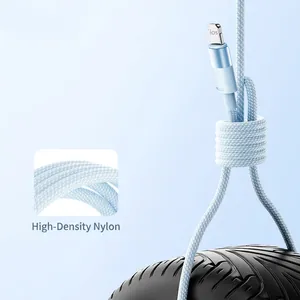 Durable blue braided Lightning charging cable lifting a heavy tire for strength.