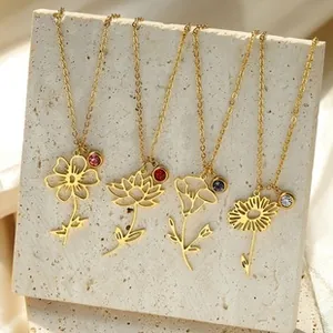 Detailed view of four elegant gold birth flower necklaces with colorful gemstones