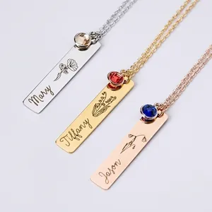 Detailed view of three custom engraved bar necklaces with birthstones and flowers
