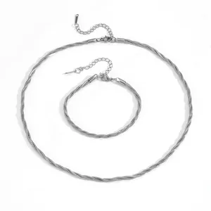 Macro detail of silver-toned triple-braided snake chain necklace and bracelet set
