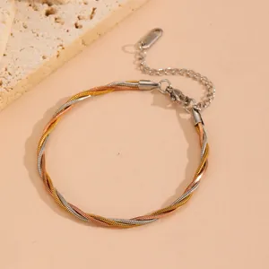 Close-up of tricolor braided snake chain bracelet in polished titanium steel finish