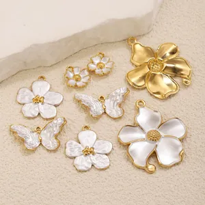 Detailed view of French vintage stainless steel flower and butterfly pendants.