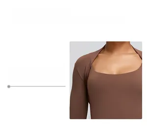 Detail of brown long sleeve sports shrug showing neckline and shoulder fit design