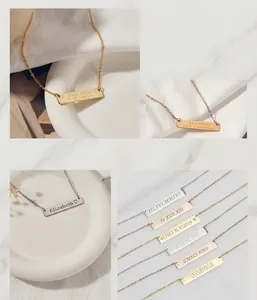 Close-up of personalized rectangular bar necklaces featuring custom Roman numeral engravings