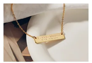 Close-up of gold bar necklace with custom date and My Love engraving detail