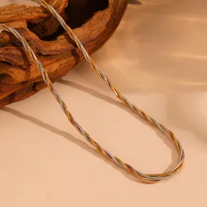 Detailed view of tricolor braided snake chain necklace in gold, silver and rose gold