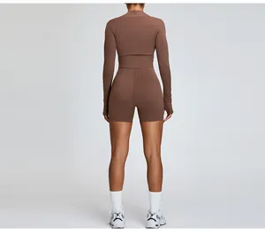 Back view detail of a brown long sleeve workout shrug and high-waist shorts set for women