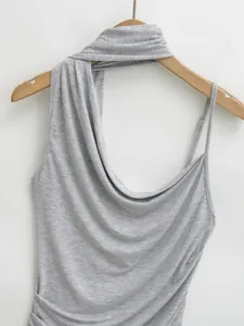 Close-up of a grey halter neck tank top with draped fabric detail on a hanger