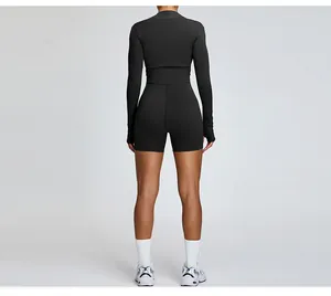 Detailed back view of women's black long-sleeved sports shrug and athletic shorts set