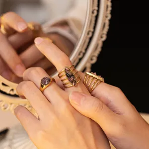 Vintage gold-plated titanium steel rings featuring stone inlay and unique wrapped line design
