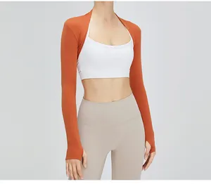 Close-up of a women's cropped orange sports shrug for yoga and fitness sessions