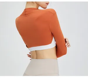 Detail of burnt orange cropped yoga shrug bolero showing back view and sleeves.