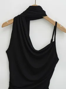 Detailed macro view of black halter neck vest with asymmetrical strap design for women