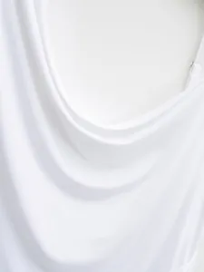 Detailed view showing the soft white fabric draping on an elegant women's cowl neck top.